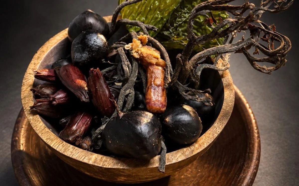 Chestnuts and pine nuts with wild mushrooms in a wooden bowl