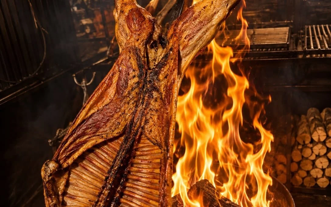 Magellanic lamb on the cross over a wood fire